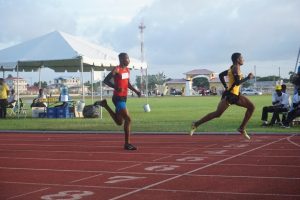 Daniel Williams glances at the clock before setting a new 100m U-18 record last week at the National Track and Field
