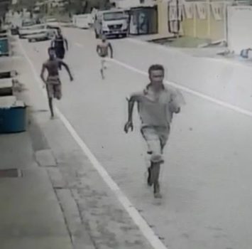 An image taken from CCTV footage of El Carmen residents along with a police officer giving chase to a bandit who robbed a shop in the area yesterday.