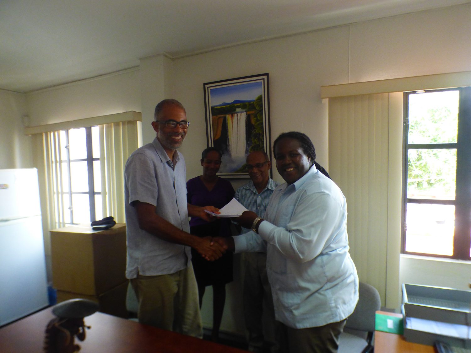 Permanent Secretary Joslyn McKenzie (right) and TCG’s Managing Director Timothy McIntosh shaking hands on the deal. (Ministry of Natural Resources photo)