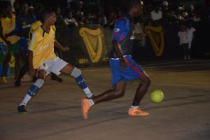 Desmond Cottam (left) of Sophia Bullies attempts to challenge John Waldron of Bent Street for possession of the ball, during their final group clash at the Albouystown Tarmac in the Guinness ‘Greatest of the Streets’ Georgetown Zone.
