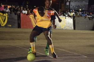 Solid as a Rock-Tyrese Forde of Leopold Street shielding the ball from a California Square player, during their quarterfinal showdown in the Guinness ‘Greatest of the Streets’ Georgetown Zone at the National Cultural Center tarmac, Thursday night.