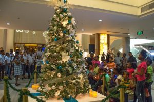 The Christmas tree at the Marriott Hotel after it was lit. It is surrounded by the children and the Bishops’ High School Choir (DPI photo)