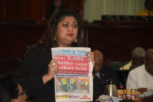 Priya Manickchand holding up a copy of Stabroek News in Parliament yesterday.