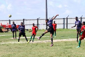 Sebastian Edwards of Pouderoyen clearing an attempted pass from the his defensive third, during his team’s clash with the GDF at the Den Amstel ground, in the Guyana Football Federation (GFF) ‘Super 16 Year-end Classic