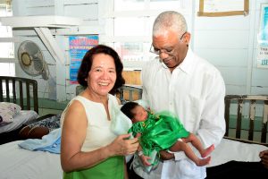 President David Granger and First Lady Sandra Granger with one of the Christmas Day babies (Ministry of the Presidency photo)