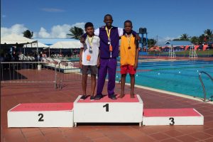 Leon Seaton on the podium after recording a personal best time in the 50m freestyle event at the just-concluded National Schools Swimming Championships.