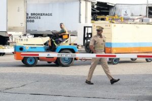 An Airport Authority security officer searches a vehicle entering the airport’s cargo bond area in Piarco on Wednesday, following a million-dollar heist.