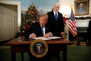 With Vice Pence Mike Pence looking on, U.S. President Donald Trump signs an executive order after he announced the U.S. would Jerusalem as the capital of Israel, in the Diplomatic Reception Room of the White House in Washington, U.S., December 6, 2017. REUTERS/Kevin Lamarque