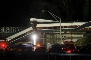 Rescue personnel and equipment are seen working into darkness at the scene where an Amtrak passenger train derailed on a bridge over interstate highway I-5 in DuPont, Washington, U.S. December 18, 2017. REUTERS/Steve Dipaola