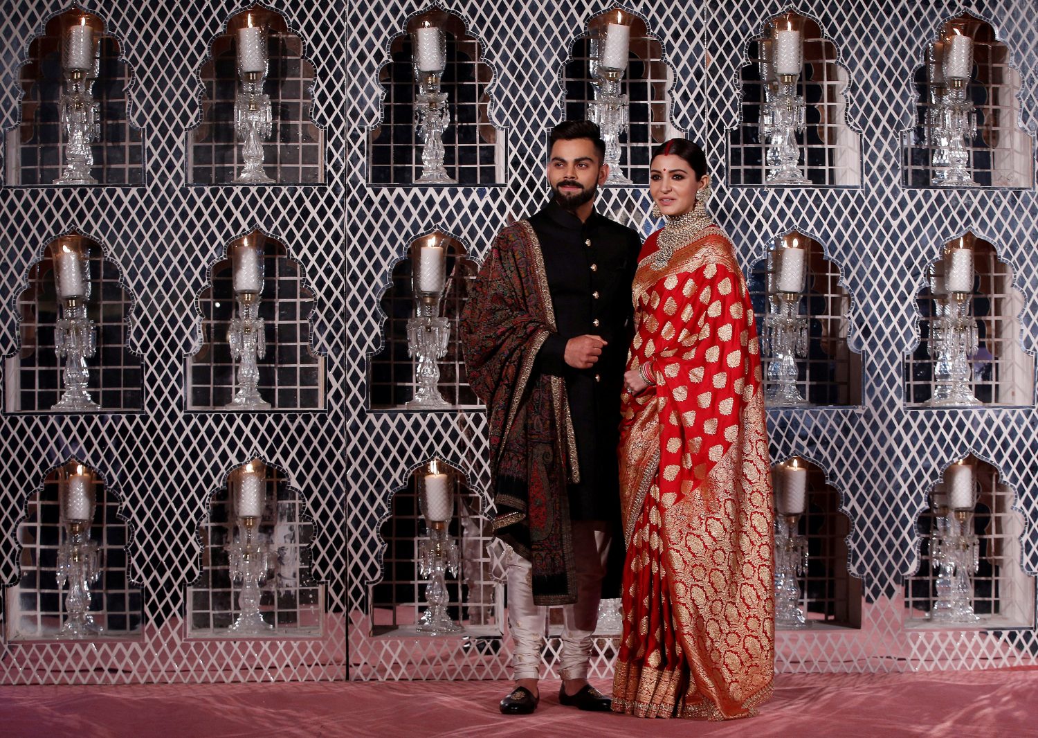 India’s cricket team captain Virat Kohli (L) and his wife, Bollywood actress Anushka Sharma, pose during a photo opportunity at their wedding reception in New Delhi, India December 21, 2017. REUTERS/ Adnan Abidi TPX IMAGES OF THE DAY