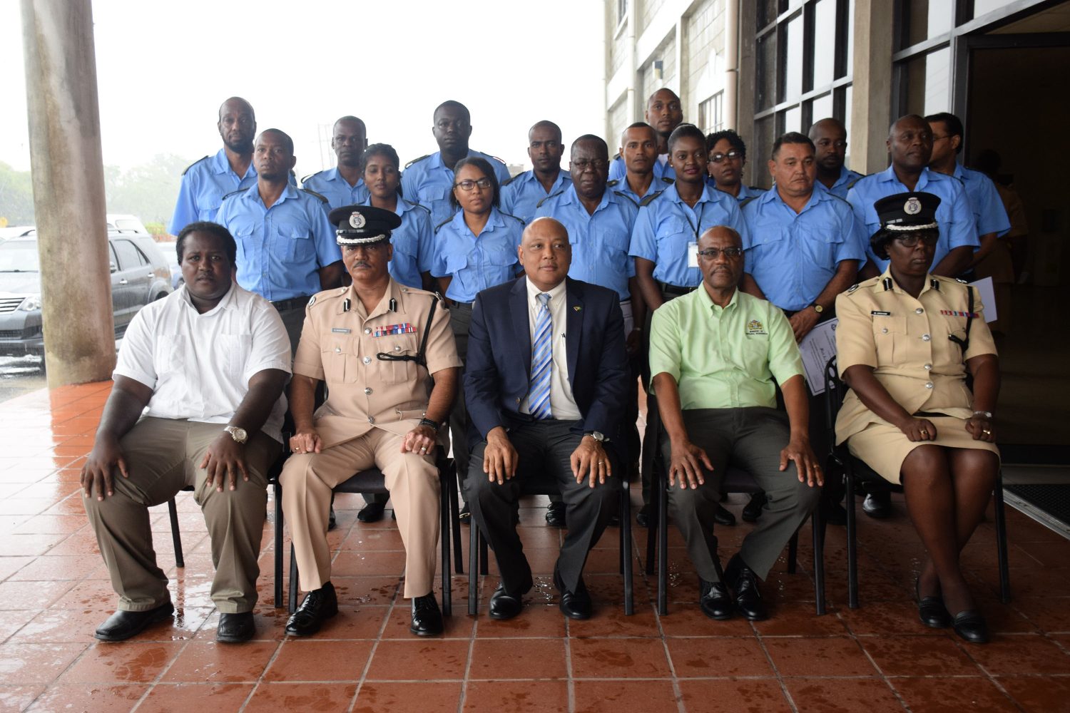The wardens are standing in this DPI photo. Minister of Natural Resources Raphael Trotman is seated at centre. Police Commisisioner (ag) David Ramnarine is seated second from left.