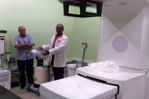  Dr. Sayan Chakraborty explains how the brachytherapy machine works, while Dr. Syed Ghazi looks on.