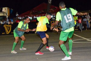 Flashback- Trevon Lythcott (centre) of ESPN trying to maintain possession of the ball while Kacy John (left) and Domini Garnett of Agricola get ready to pounce during their quarterfinal clash in the Greatest of the Streets’ West Demerara/East Bank Demerara Zone 