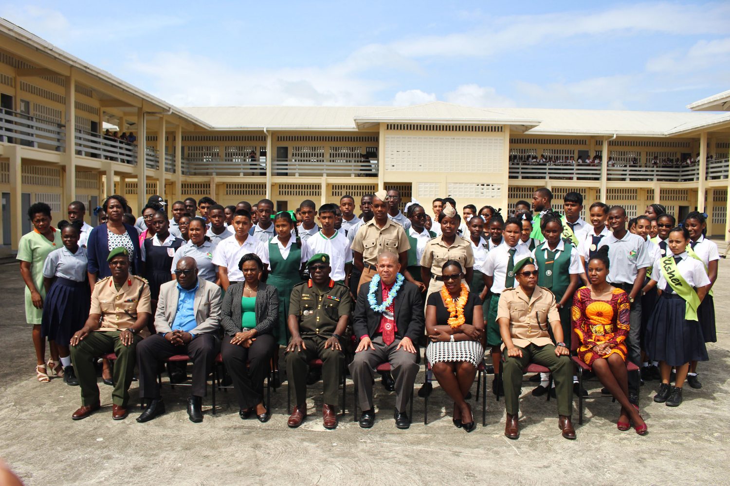 Officials from the ministries of Education and Social Cohesion, along with officers from the Guyana Defence Force, pose with students and teachers at the launch of the National Cadet Corps Programme yesterday. Seated in the photo are: Chief Education Officer Marcel Hutson (second, from left); Chief-of-Staff of the GDF Brigadier Patrick West (fourth, from left); Minister of Social Cohesion Dr George Norton (fourth, from right); and Minister of Education (third from right). (Photo by Keno George)