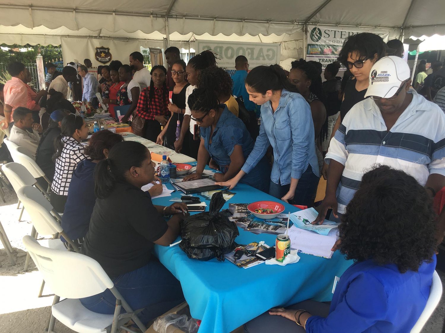Residents from Wales, West Bank Demerara and its surrounding communities engaging business representatives at the job fair yesterday at Patentia. 

