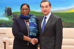 Suriname’s Foreign Minister Yldiz Pollack-Beighle (left) greets China’s Foreign Minister Wang Yi at the meeting.   (Caricom photo)
