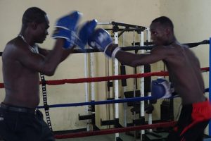 Dexter ‘Cobra’ Gonsalves hits the pad of trainer, Joseph Murray during a recent workout at the Andrew ‘Sixhead’ Lewis Gym. Gonsalves and Venezuelan, Felipe Barcelo, will be part of the six-fight ‘Bad Blood’ card on Saturday at the Cliff Anderson Sports Hall.