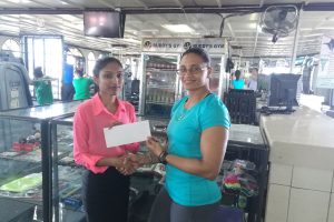 Marketing Manager of the Gym, Christine Dharry (left) yesterday presented a sponsorship pact to GAPF Committee Member and Master’s One National gold medalist Nadina Taharally to help offset expenses of the competition.
