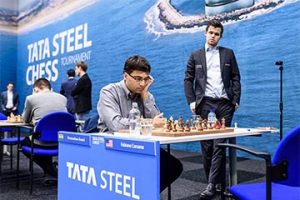Anand strikes! Veteran chess player and Indian grandmaster Viswanathan Anand, 48, studying the chess board intently as he demolished American grandmaster Fabiano Caruana (not in picture) in the third round of the Tata Steel Masters Tournament last week at Wijk aan Zee in the Netherlands. The curious onlooker is World Champion Magnus Carlsen of Norway. Following his victory over Caruana, Anand joined Anish Giri for the lead in the Tournament which ends next Sunday. (Photo: Alina l’Ami)