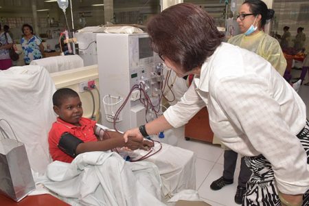 First Lady, Sandra Granger greets dialysis patient  Jamali Corbin at the Doobay Medical Centre.  (Ministry of the Presidency photo)