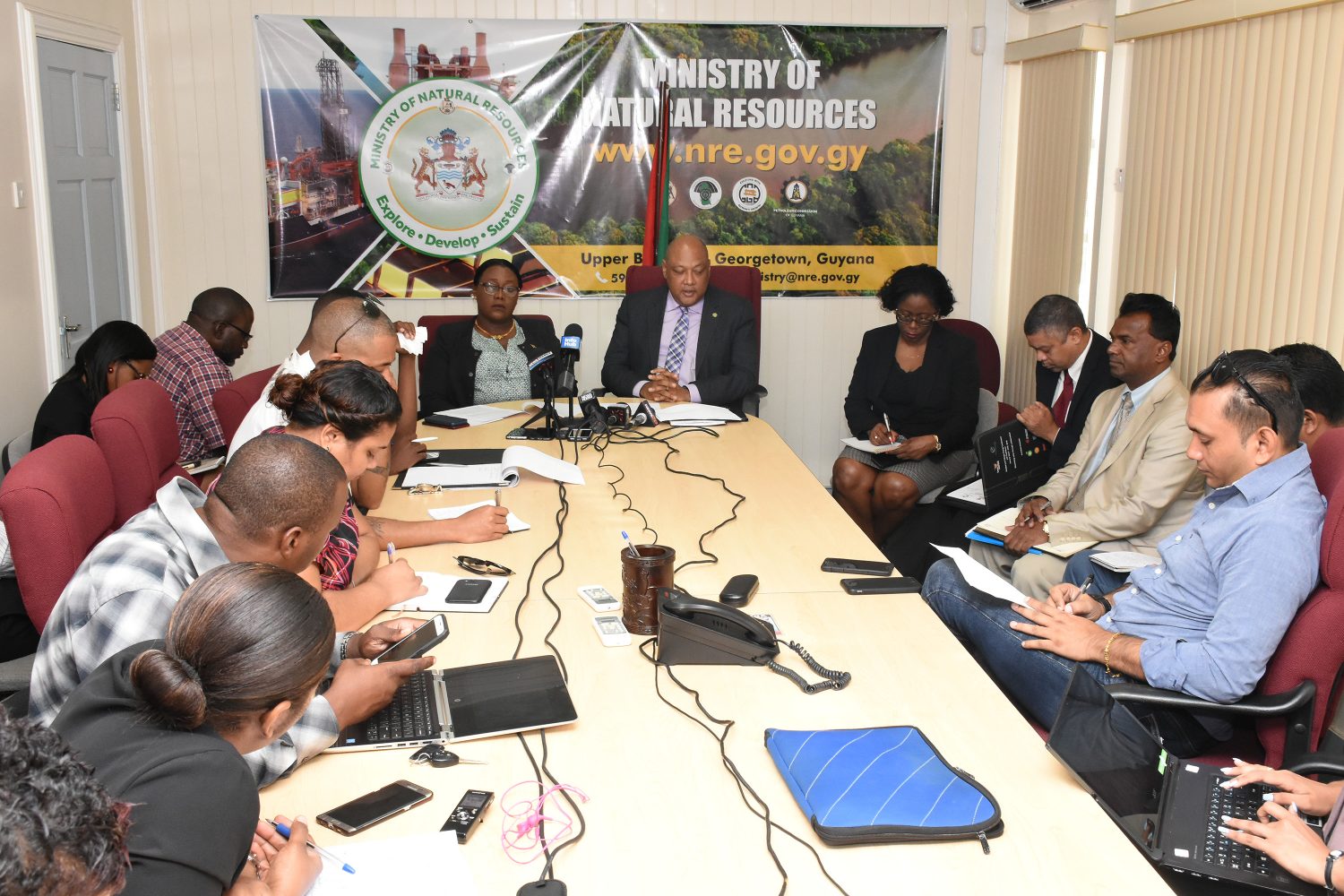 Minister of Natural Resources Raphael Trotman (right at head of table) speaking at the press conference (Department of Public Information photo)