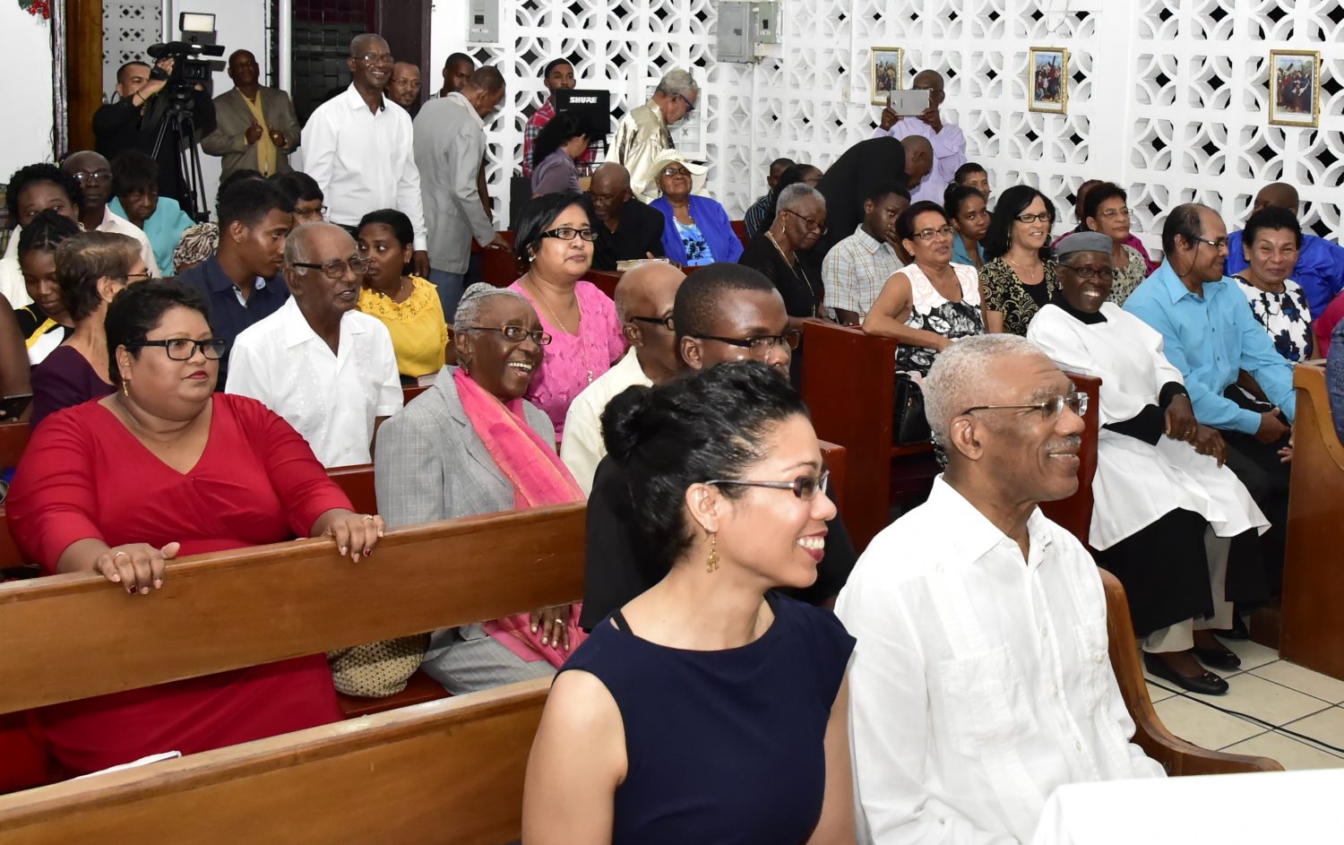 President David Granger (right in foreground), on Sunday evening, joined with the congregation at the St. Mary’s Anglican Church at Soesdyke, East Bank Demerara to ring in the New Year. The Head of State was accompanied by his daughter,  Afuwa Granger. (Ministry of the Presidency photo)