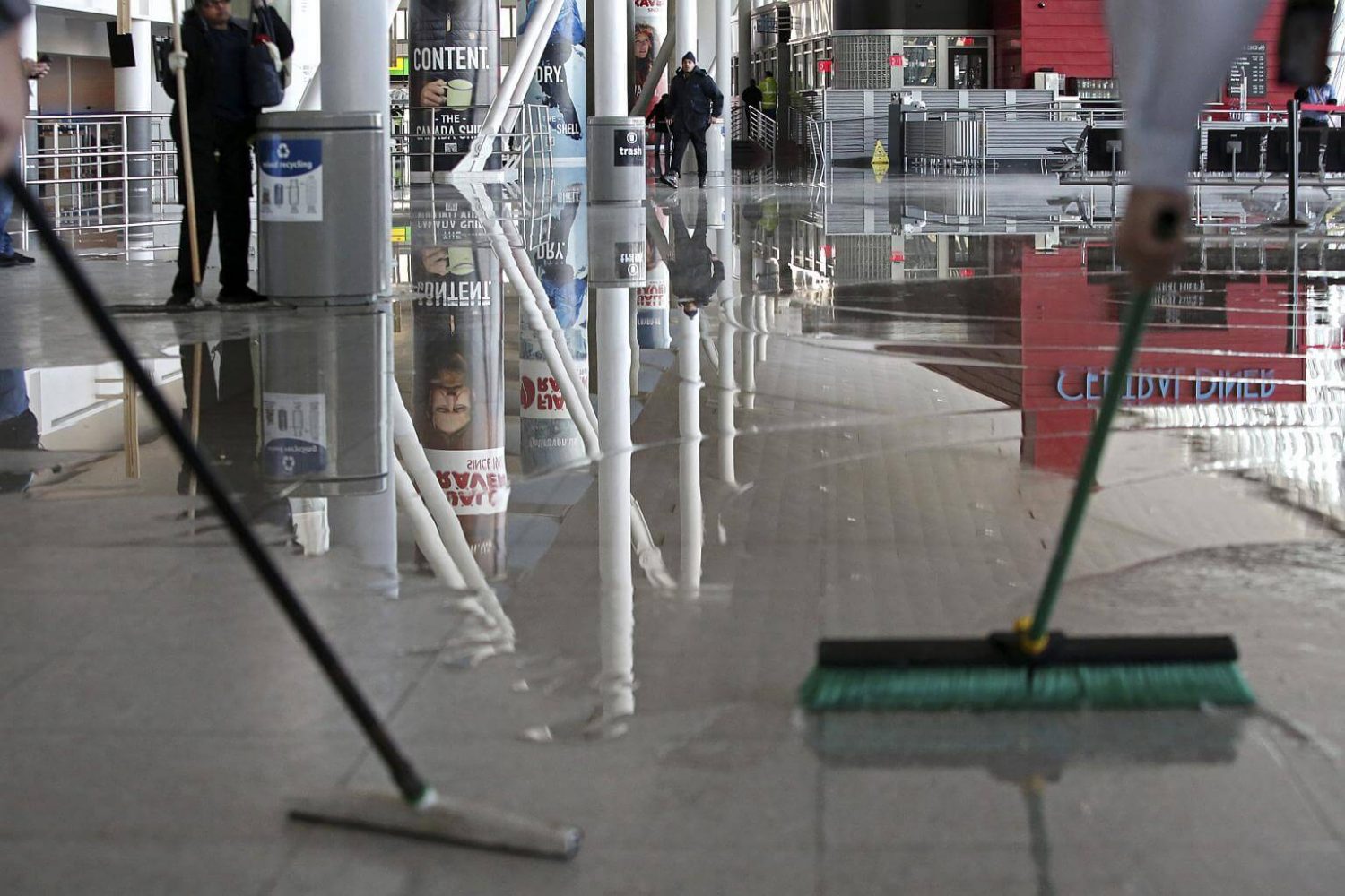Employees clean up water from a broken water main at Terminal 4 of John F. Kennedy International Airport in New York, on Jan 7, 2018. PHOTO: NYTIMES