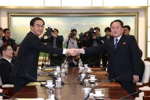 Head of the North Korean delegation, Ri Son Gwon (right) shakes hands with his South Korean counterpart Cho Myoung-gyon during their meeting at the truce village of Panmunjom in the demilitarised zone separating the two Koreas, South Korea, January 9, 2018. REUTERS/Korea Pool