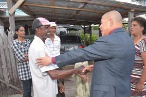 Minister of Social Cohesion Dr. George Norton offering words of hope to Nadir Mohamed, the father of Shazam Mohamed, who lost his life ten years ago (Ministry of the Presidency Photo) 