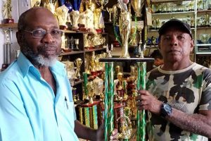  In picture, Trophy Stall’s Brian Sealey, right, hands over the winning trophy to former national player and coach Lennox Arthur.