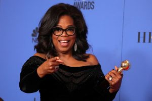 Oprah Winfrey poses backstage with her Cecil B. DeMille Award. REUTERS/Lucy Nicholson