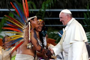 Pope Francis (R) greets members of an indigenous group from the Amazon region, at the Coliseum Madre de Dios, in Puerto Maldonado, Peru. (Reuters photo)