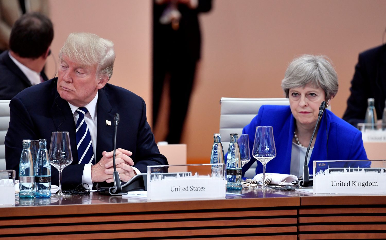 FILE PHOTO: US President Donald Trump and Britain’s Prime Minister Theresa May wait at the start of the first working session of the G20 meeting in Hamburg, Germany, July 7, 2017. REUTERS/John MACDOUGALL/Pool/File Photo