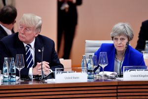 FILE PHOTO: US President Donald Trump and Britain's Prime Minister Theresa May wait at the start of the first working session of the G20 meeting in Hamburg, Germany, July 7, 2017. REUTERS/John MACDOUGALL/Pool/File Photo