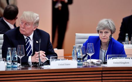 FILE PHOTO: US President Donald Trump and Britain's Prime Minister Theresa May wait at the start of the first working session of the G20 meeting in Hamburg, Germany, July 7, 2017. REUTERS/John MACDOUGALL/Pool/File Photo