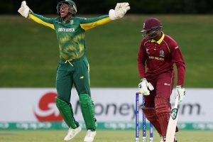 West Indies batsman Bhaskar Yadram falls to a catch at the wicket as Wandile Makwetu celebraetes. (Photo courtesy ICC Media)
