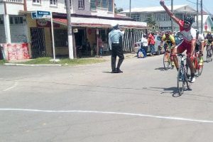 Michael Anthony celebrates his victory in yesterday’s opening 27th annual Forbes Burnham Memorial road race.