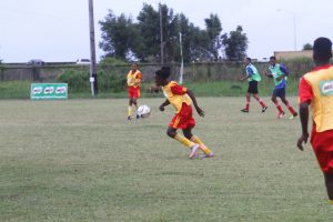 Buxton Youth Developers launching another attack during their 5-0 whipping of Charlestown Secondary yesterday at the Ministry of Education Ground, Carifesta Avenue. (Orlando Charles photo)