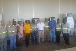 Staff of Guyana Goldfields Inc pose with Chief Executive Officer Scott Caldwell (left) and Country Manager Violet Jean-Baptiste (fifth from left) at the Marriott Hotel.
