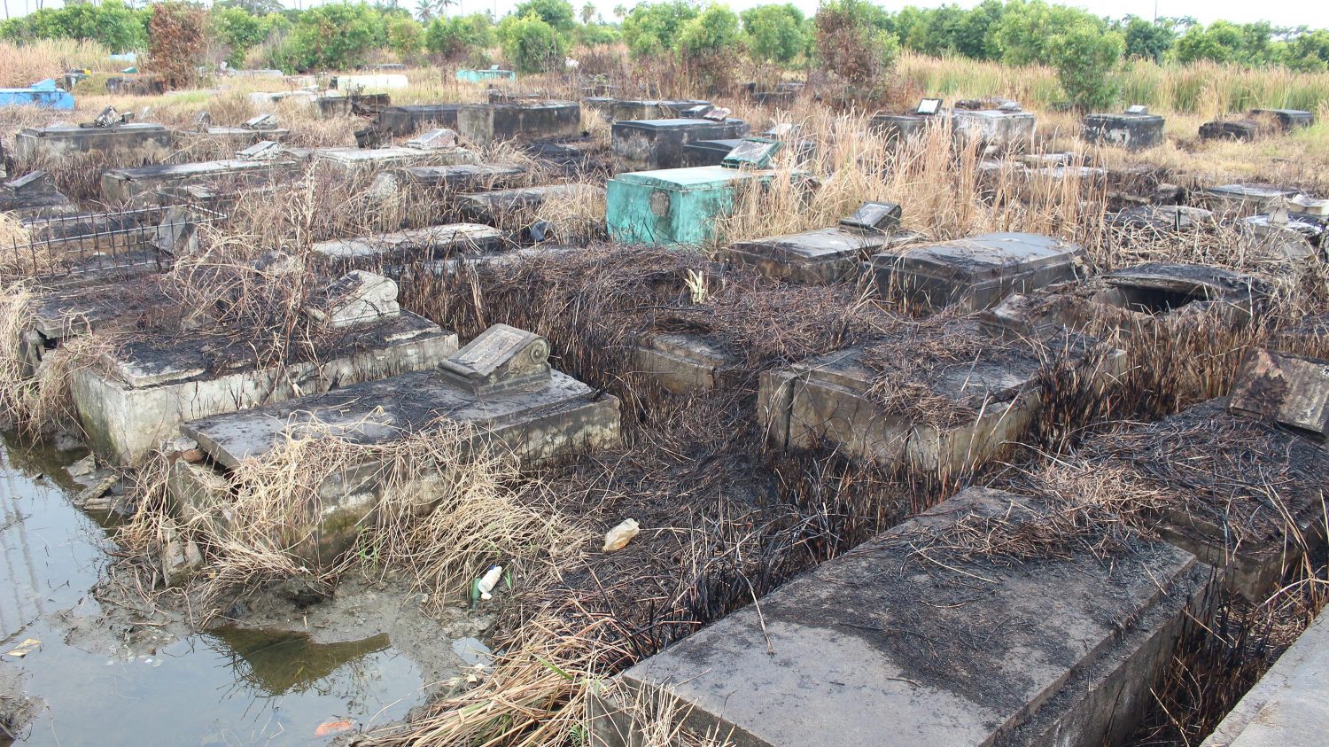 City Hall has engaged contractors to clean and clear the Le Repentir Cemetery at a cost of over $100 million. While the contract scope includes the removal of debris, there have been reports of grass being burnt rather than removed. In this Keno George photo, broken and cracked tombs can be seen surrounded by burnt and blackened grass.
