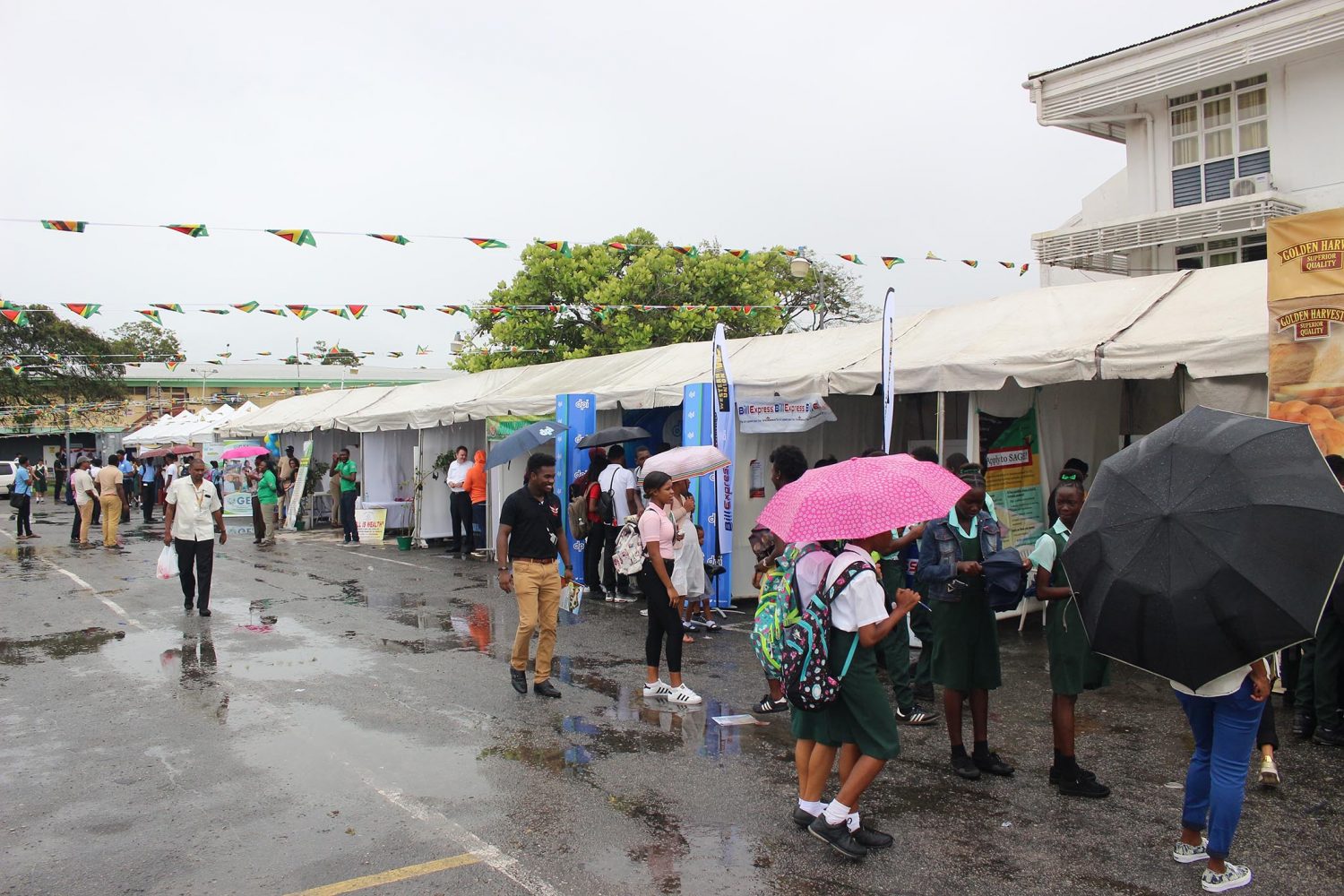 Out in the rain: Despite the rain, hundreds of persons came out to attend the University of Guyana’s Open Day on Friday. (Keno George photo) 