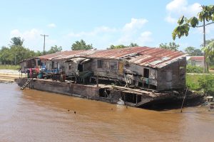 Home sweet home? This ramshackle structure, moored on a bank of the Essequibo River, is home to at least 20 persons at Byberabo, Bartica. (Mariah Lall photo) 