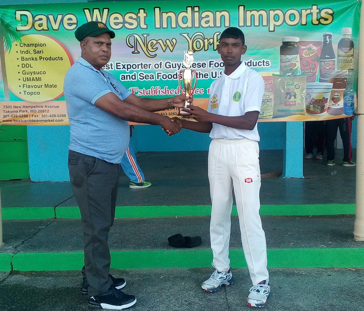 Man of the Match Romel Datterdeen receives his award from match referee Moses Roopnarine