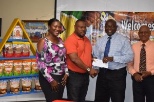 NAMILCO Finance Controller Fitzroy McLeod (2nd from right) handing over the cheque to Petra Organization Co-Director Troy Mendonca, in the presence of Jacklyn Boodie of Petra (left) and NAMILCO Marketing Manager Afeeze Khan