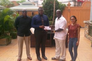 Tower Suites’ Food Beverage and Events Manager, Neilson McKenzie (second left) hands over the sponsorship pact to Head of McDonald Promotions, Alford McDonald, as Tower Suites Operations Manager Shivani Sawh (right) and GBA President Steve Ninvalle (left) look on.