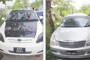 These two cars, suspected to have been stolen, were found during a raid at Monument Hill, Kuru Kururu, Soesdyke-Linden Highway. (Guyana Police Force photo)
