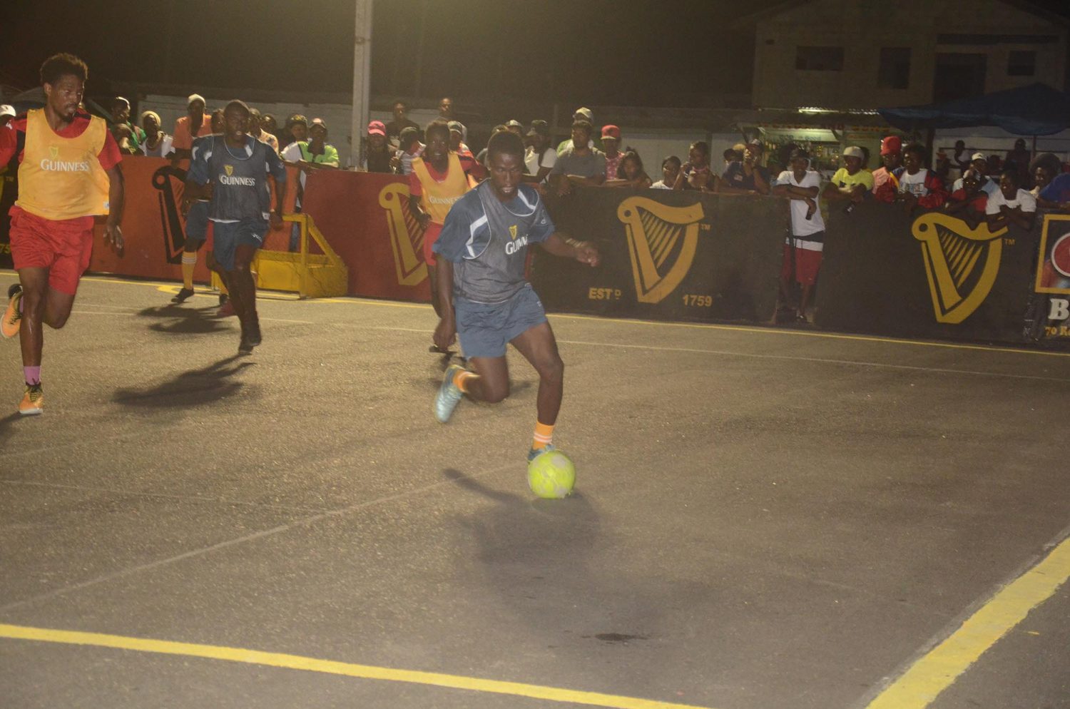 Gadi Hoyte (right) of Brothers United, on the attack against Hustlers during their group matchup at the Pouderoyen Tarmac in the Guinness ‘Greatest of the Streets’ West Demerara/East Bank Demerara Zone