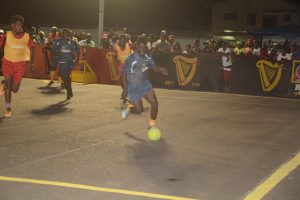 Gadi Hoyte (right) of Brothers United, on the attack against Hustlers during their group matchup at the Pouderoyen Tarmac in the Guinness ‘Greatest of the Streets’ West Demerara/East Bank Demerara Zone