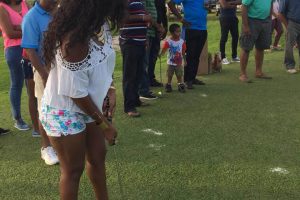 A young lady tries her hand at putting during the Lusignan Golf Club’s Innovative Greensome and Barbeque held last Sunday.