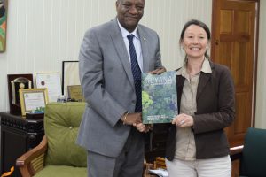 Minister of State, Joseph Harmon was presented with a book on the Frankfurt Zoological Society’s support for and work in Guyana.  (Ministry of the Presidency photo)